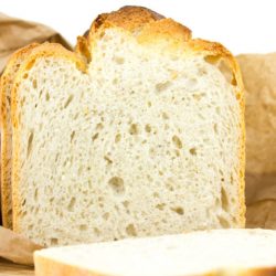 Sliced Whole Grain Bread in a Paper Bag Isolated on White