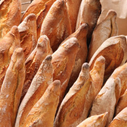 French baguettes in metal basket in bakery